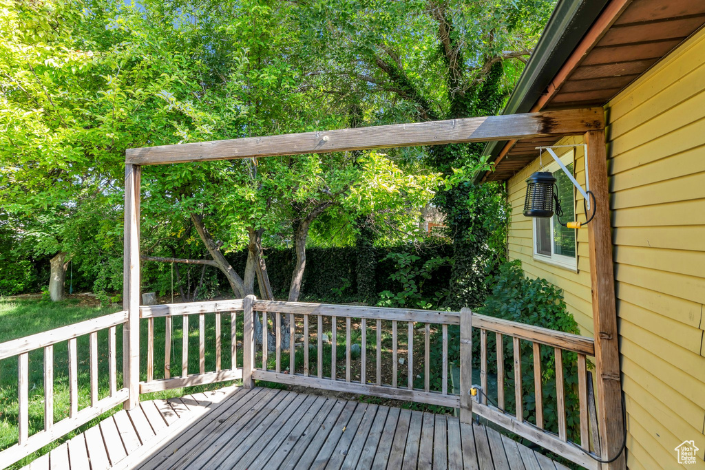 Wooden terrace featuring view of scattered trees