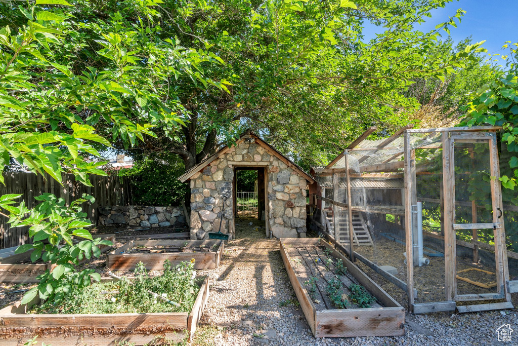 View of poultry coop featuring a garden