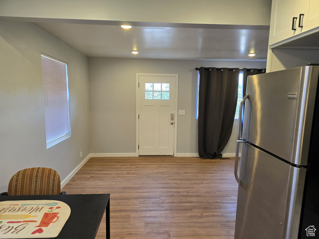 Entryway with light wood-style flooring and baseboards