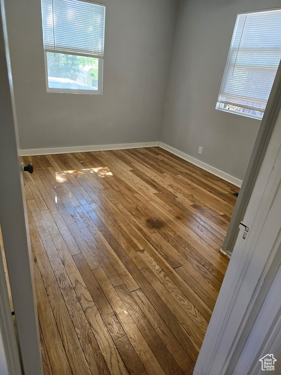 Unfurnished room with hardwood / wood-style flooring