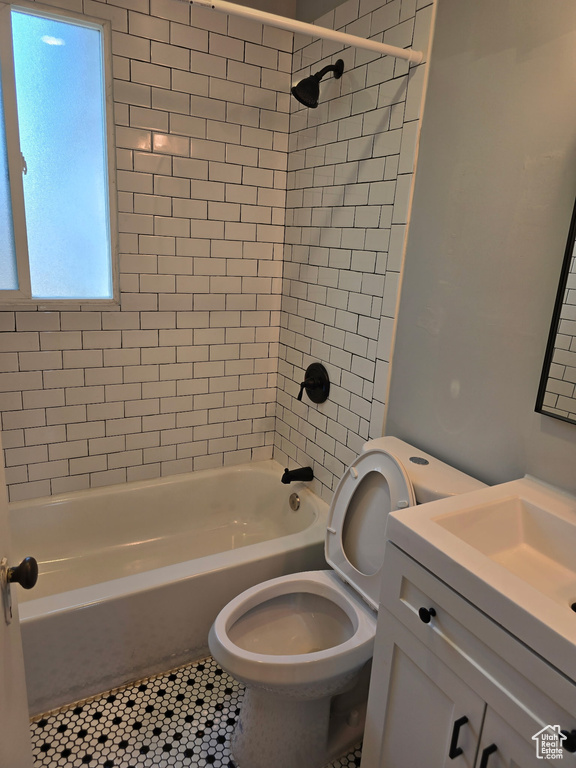 Bathroom featuring vanity, shower / washtub combination, and tile patterned floors