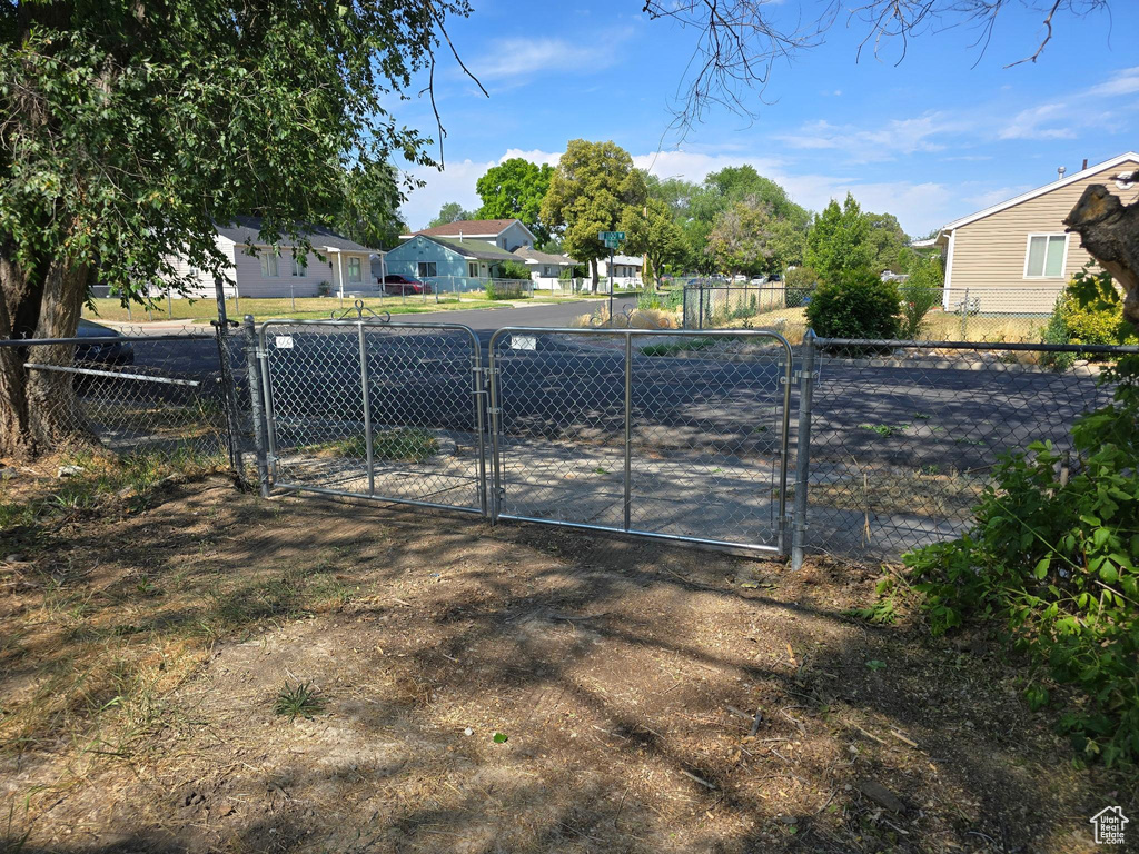 View of yard featuring a gate and a residential view