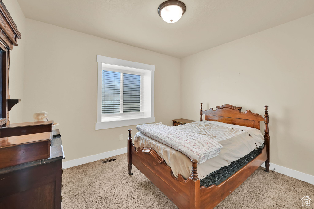 Bedroom featuring light carpet