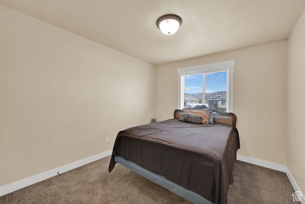 Carpeted bedroom with baseboards