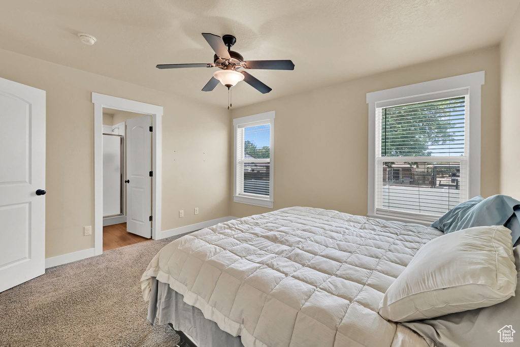 Carpeted bedroom featuring baseboards and ceiling fan