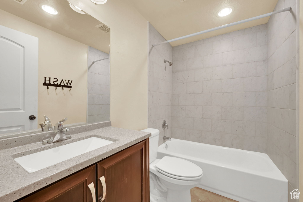 Bathroom with vanity, tub / shower combination, recessed lighting, and tile patterned floors