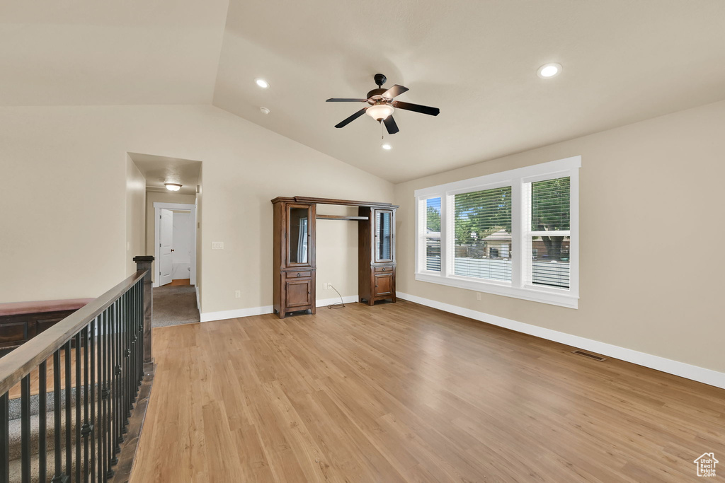 Unfurnished bedroom with lofted ceiling, light wood-type flooring, recessed lighting, a ceiling fan, and a closet
