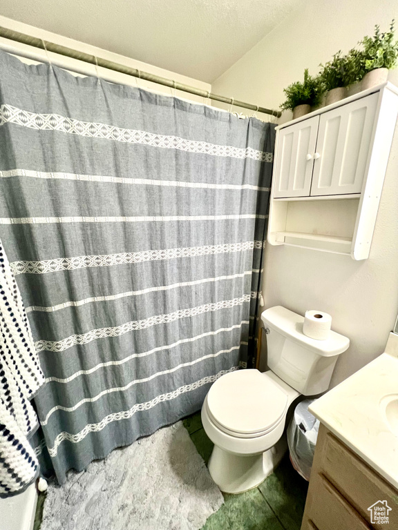 Bathroom featuring vanity, tile patterned flooring, and curtained shower