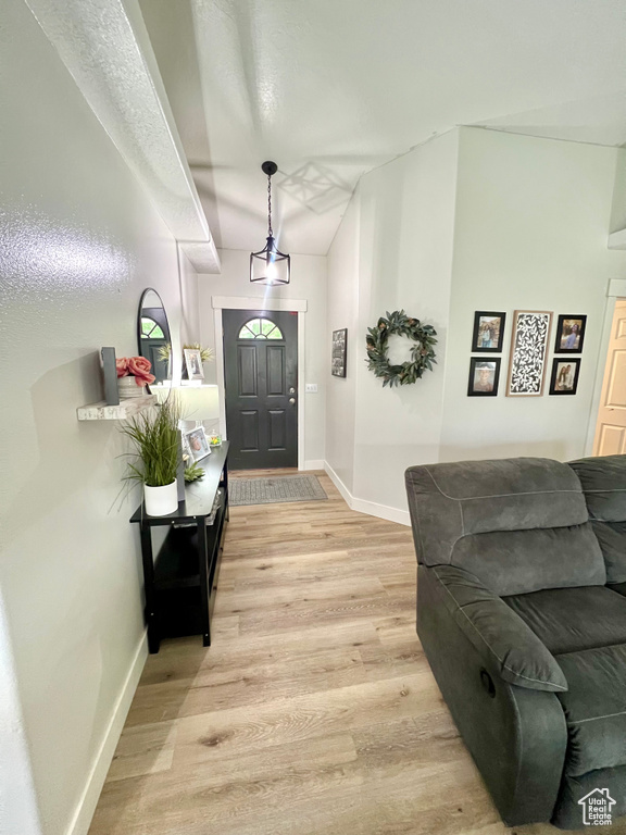 Entrance foyer with light wood-style flooring and baseboards
