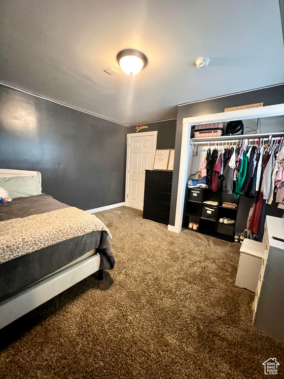 Bedroom with carpet floors and a closet