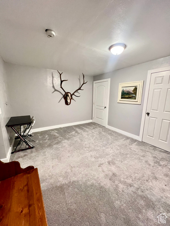 Unfurnished room featuring baseboards and carpet
