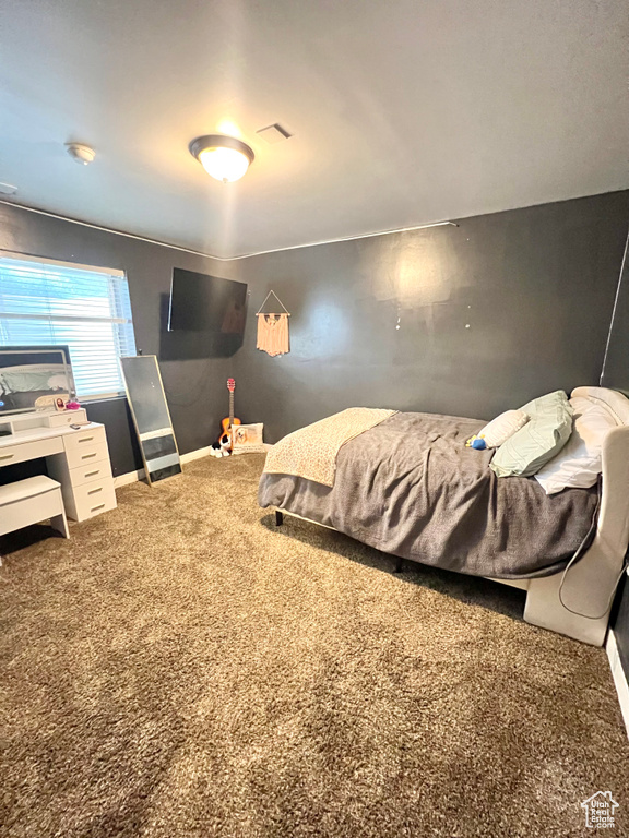 Carpeted bedroom with baseboards
