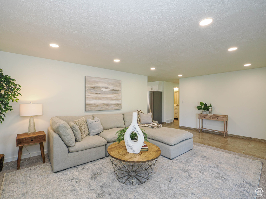 Living area featuring recessed lighting and a textured ceiling