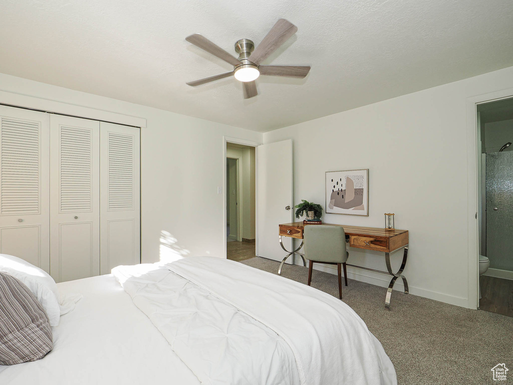 Bedroom featuring a closet, carpet floors, connected bathroom, and a ceiling fan
