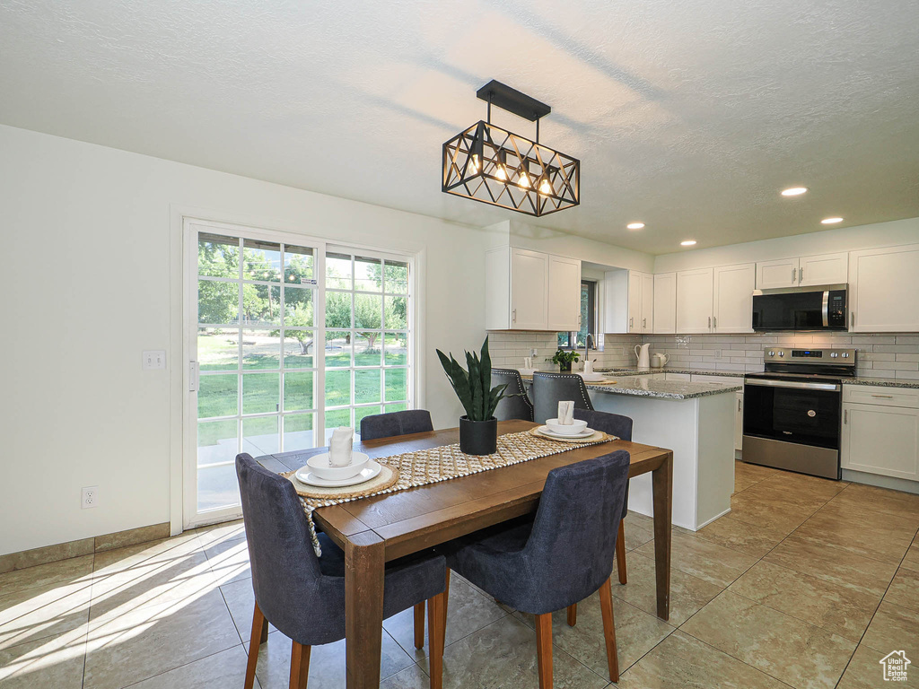 Dining space featuring recessed lighting and a textured ceiling