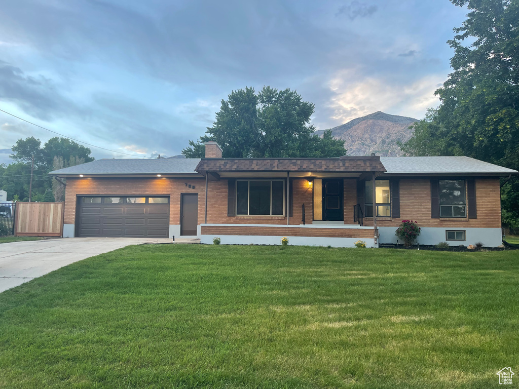 Single story home featuring covered porch, brick siding, and a front yard