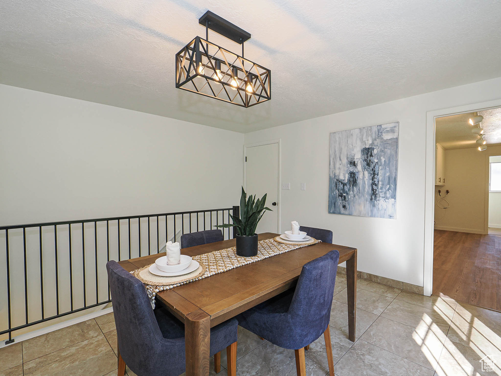 Dining room with a chandelier and a textured ceiling