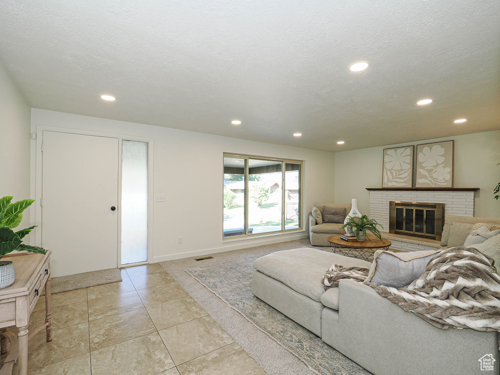 Living room with recessed lighting and a fireplace