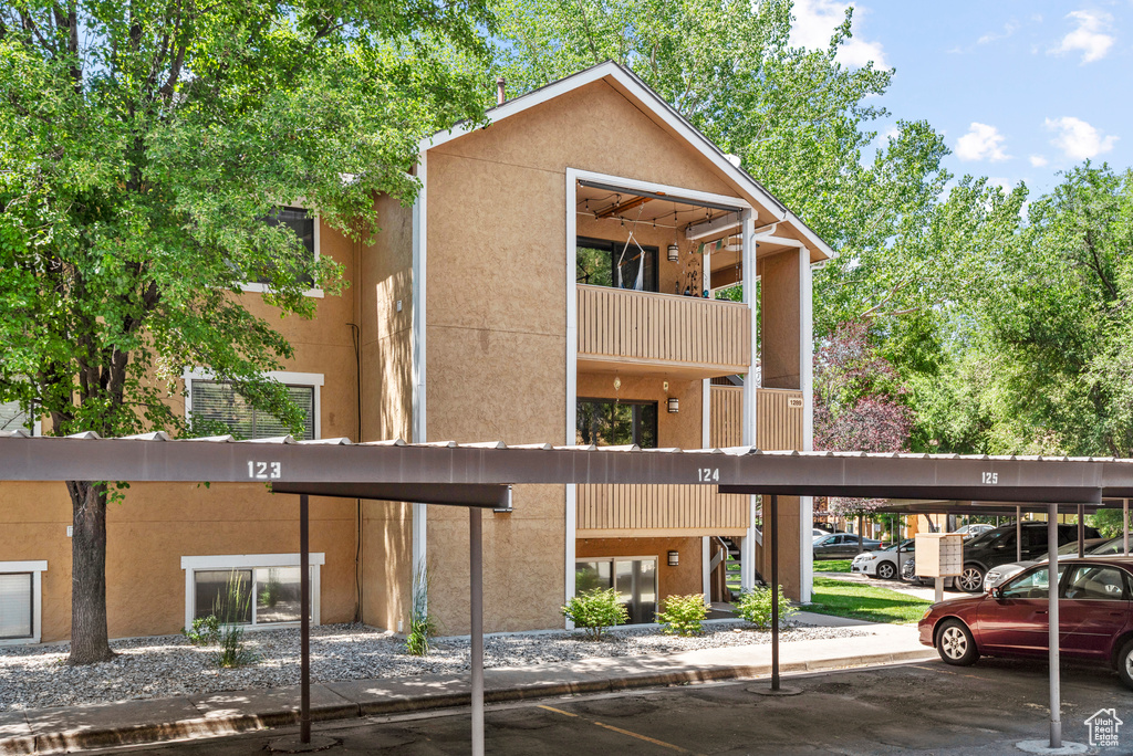 View of building exterior with covered parking