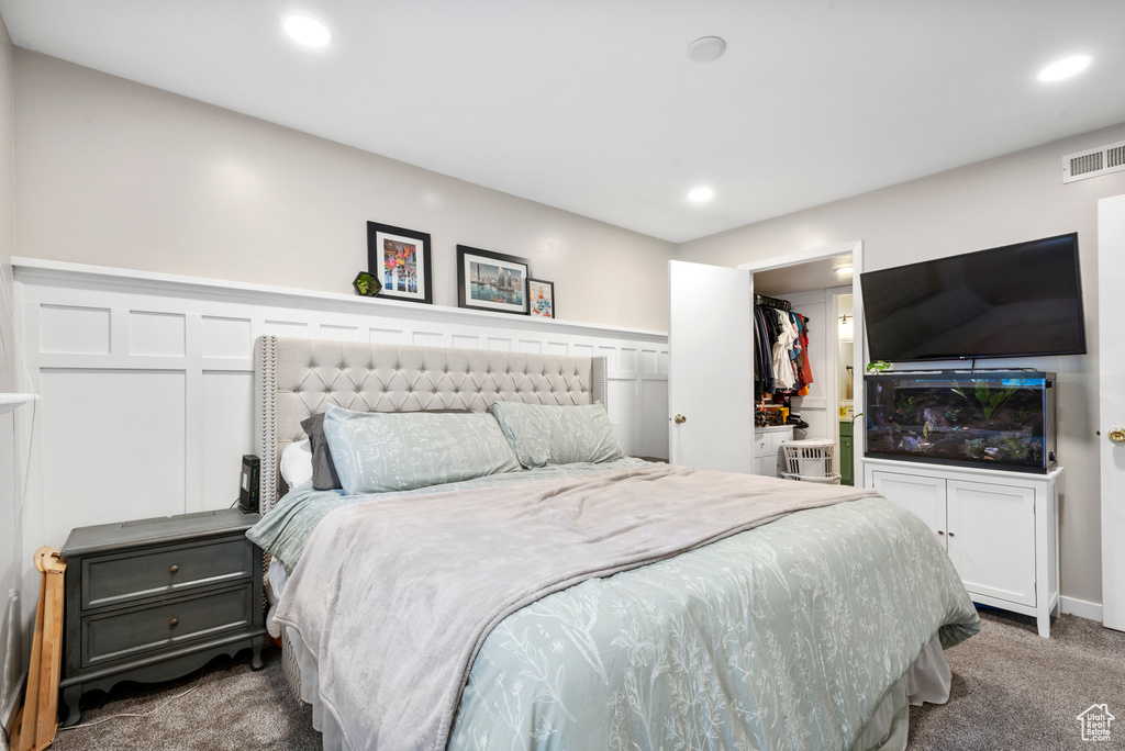 Bedroom featuring carpet floors, recessed lighting, a walk in closet, and a closet