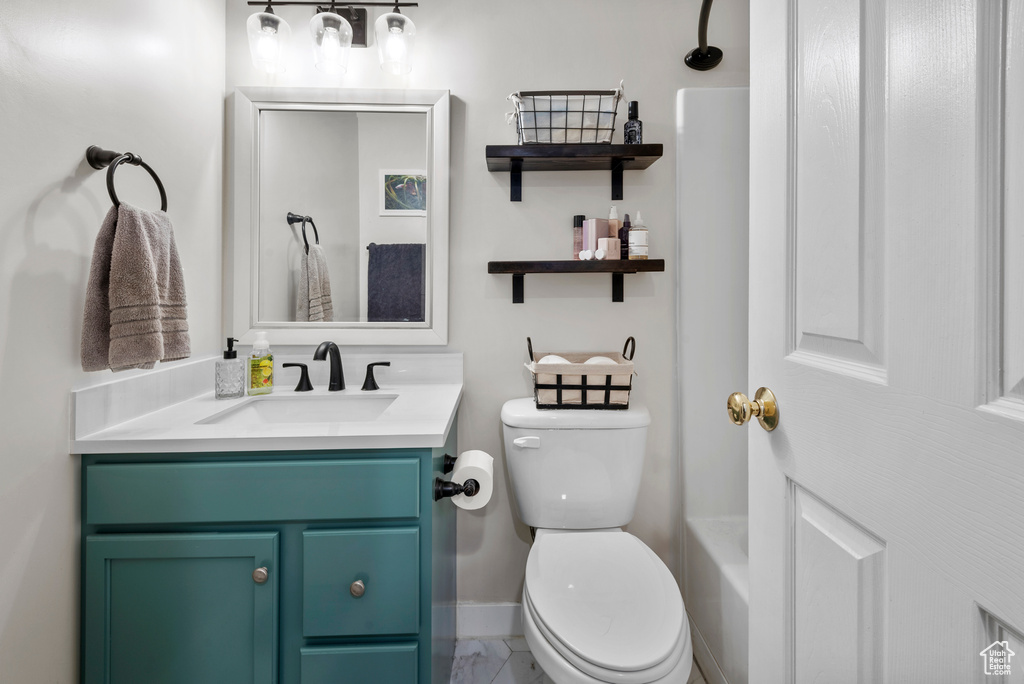 Full bathroom with vanity and marble look tile flooring
