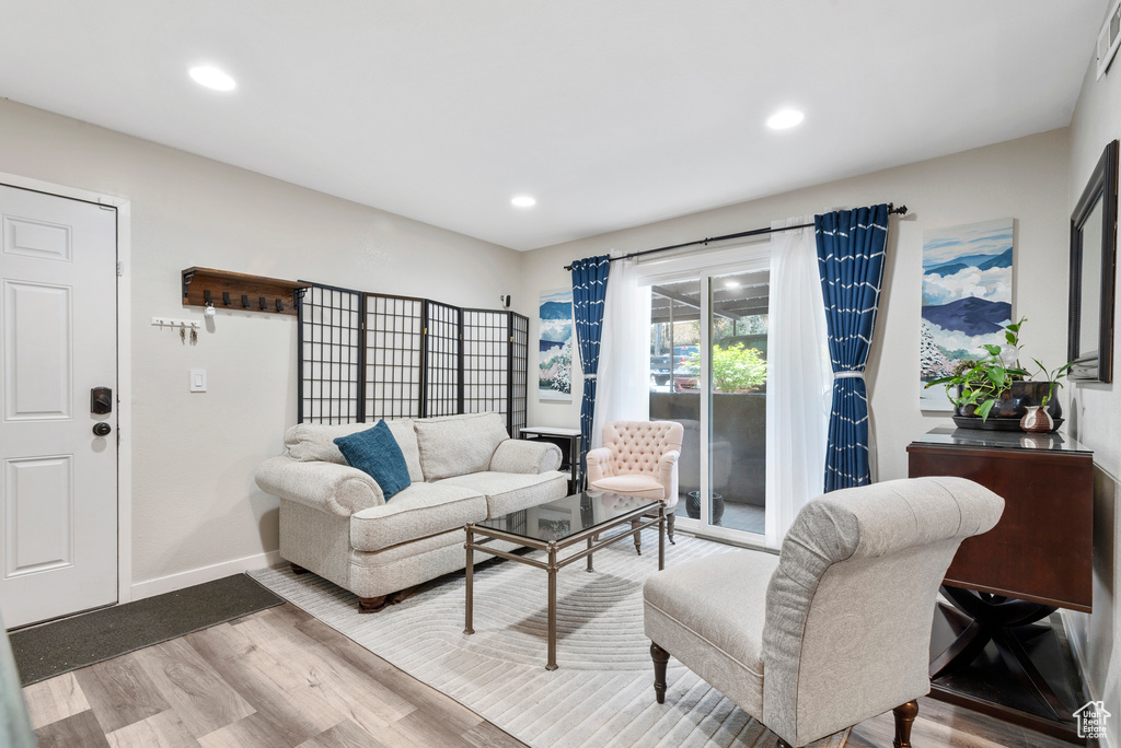 Living area featuring wood finished floors and recessed lighting