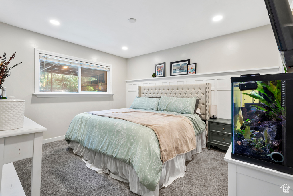 Bedroom with light colored carpet and recessed lighting