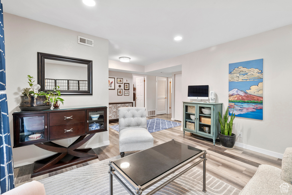 Living room with wood finished floors and recessed lighting