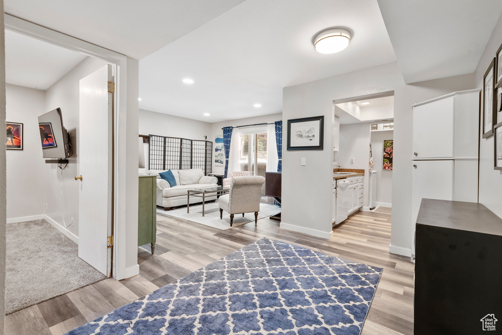 Living room featuring light wood-type flooring and recessed lighting