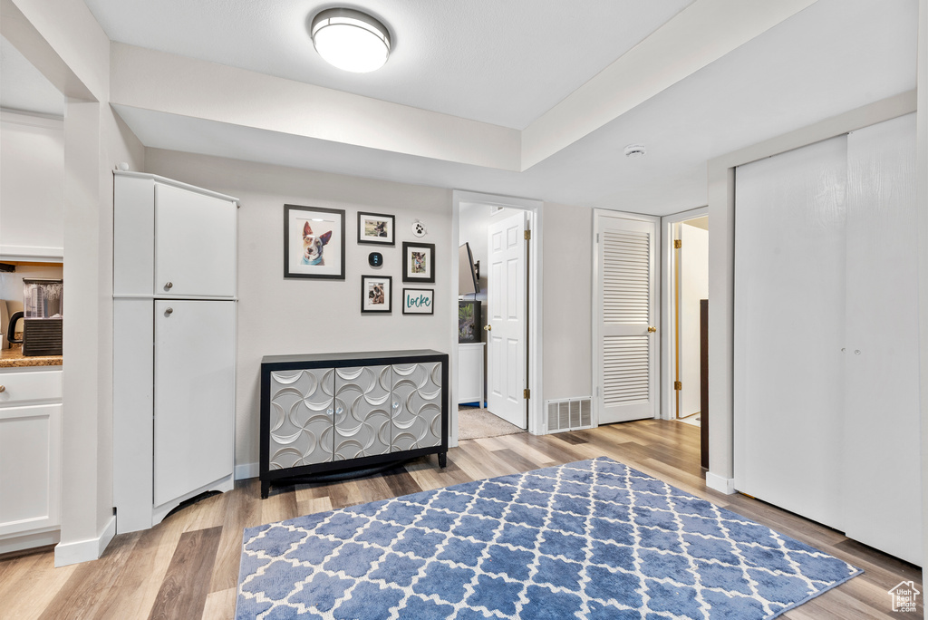 Bedroom with light wood finished floors and baseboards