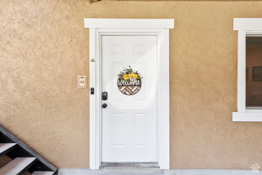 Entrance to property with stucco siding