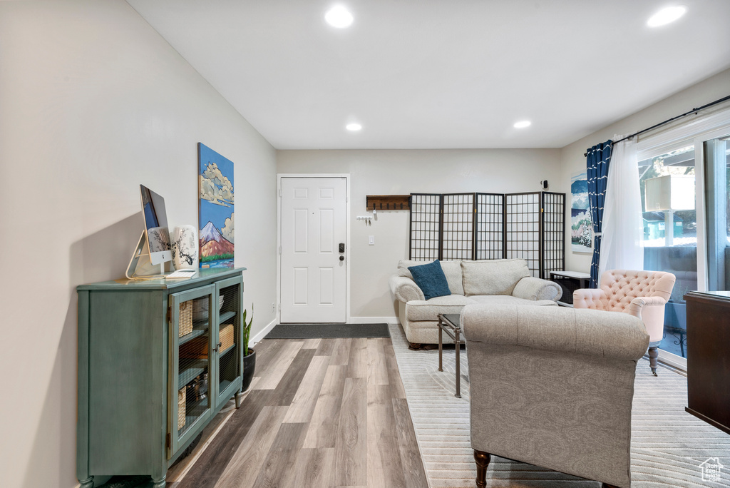 Living room with wood finished floors and recessed lighting