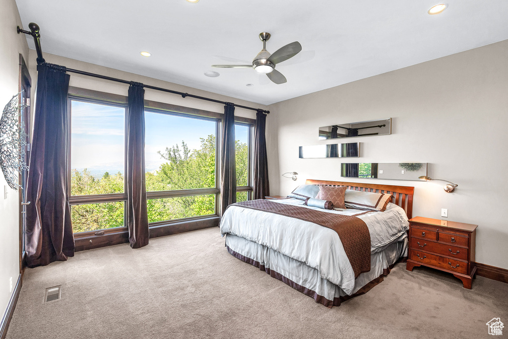 Carpeted bedroom featuring recessed lighting and a ceiling fan