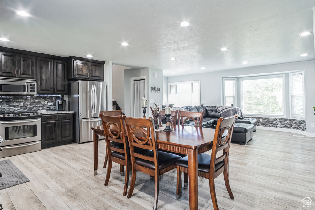 Dining room featuring light wood-style flooring and recessed lighting