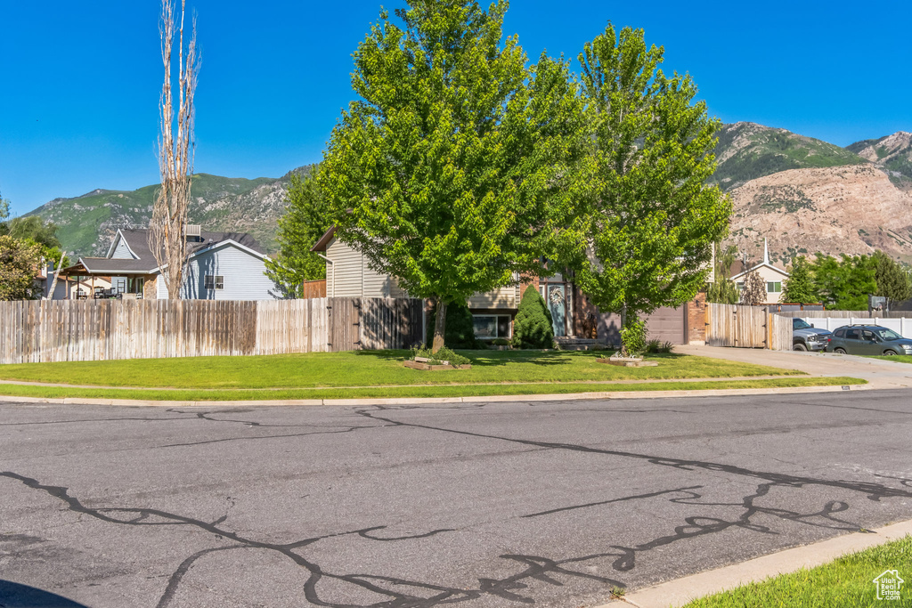 View of front of home with a mountain view and an attached garage