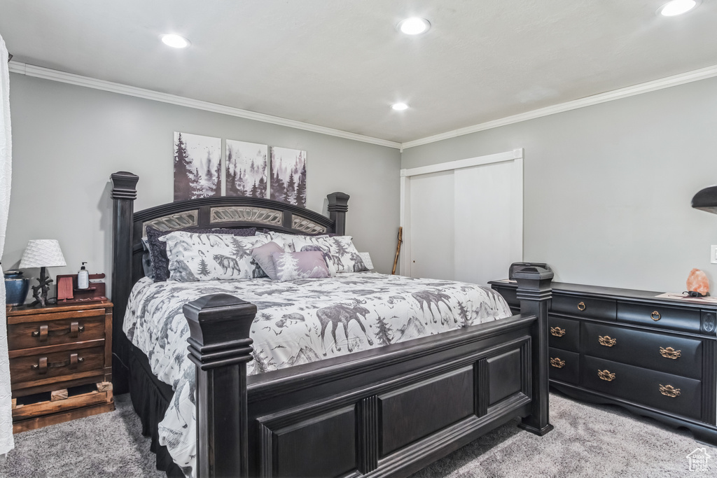 Bedroom featuring ornamental molding, a closet, recessed lighting, and light carpet