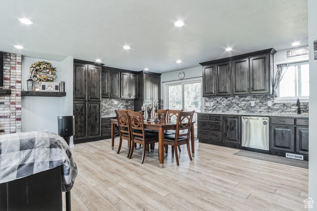 Dining room featuring light wood-style flooring and recessed lighting