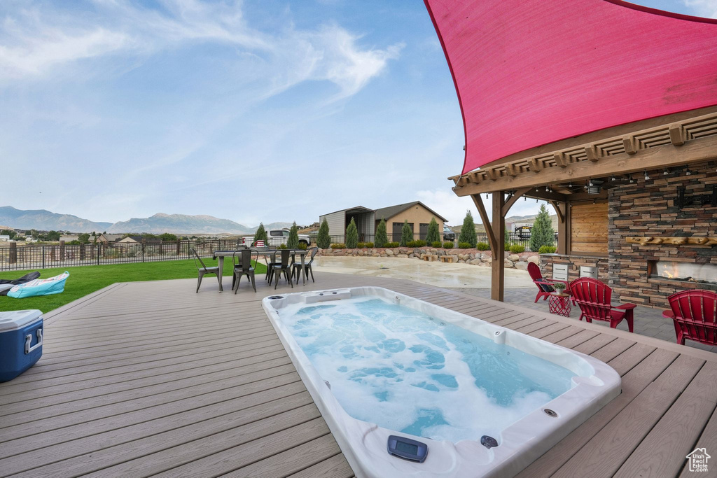 View of swimming pool with a deck with mountain view and outdoor dining space
