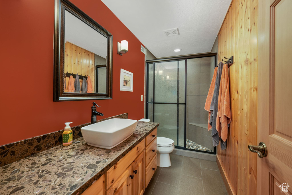 Bathroom featuring vanity and a stall shower