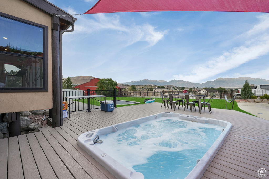 View of pool with a deck with mountain view and outdoor dining space