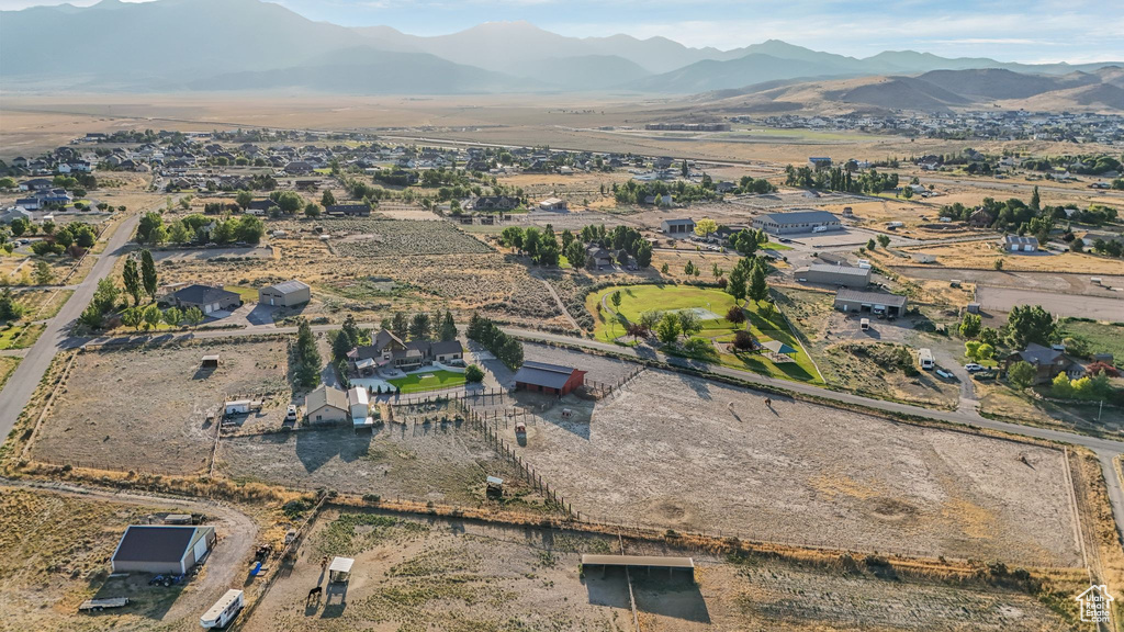 Aerial overview of property's location with a mountainous background and rural landscape