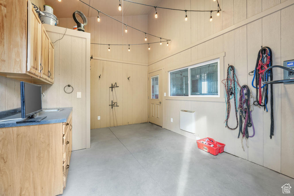 Kitchen featuring concrete flooring and a high ceiling