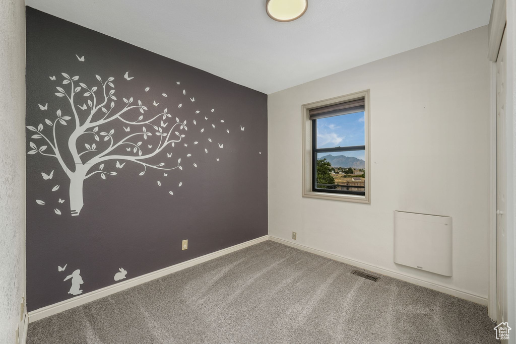 Carpeted empty room with baseboards