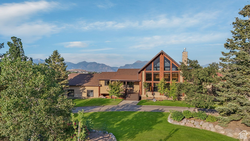 Log-style house with a front yard and a mountain view