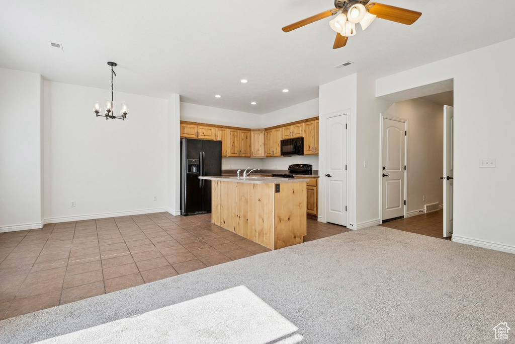 Kitchen with black appliances, a chandelier, a ceiling fan, tile patterned flooring, and recessed lighting