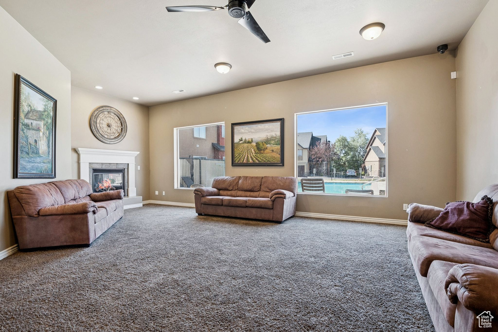 Living area featuring carpet flooring, healthy amount of natural light, a fireplace, and recessed lighting