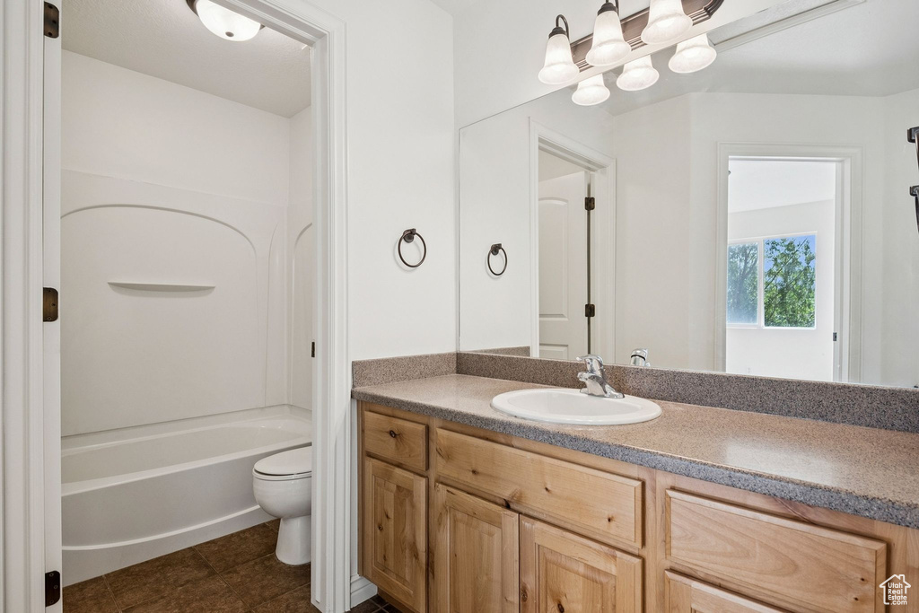 Bathroom with vanity, tile patterned flooring, and shower / bathtub combination