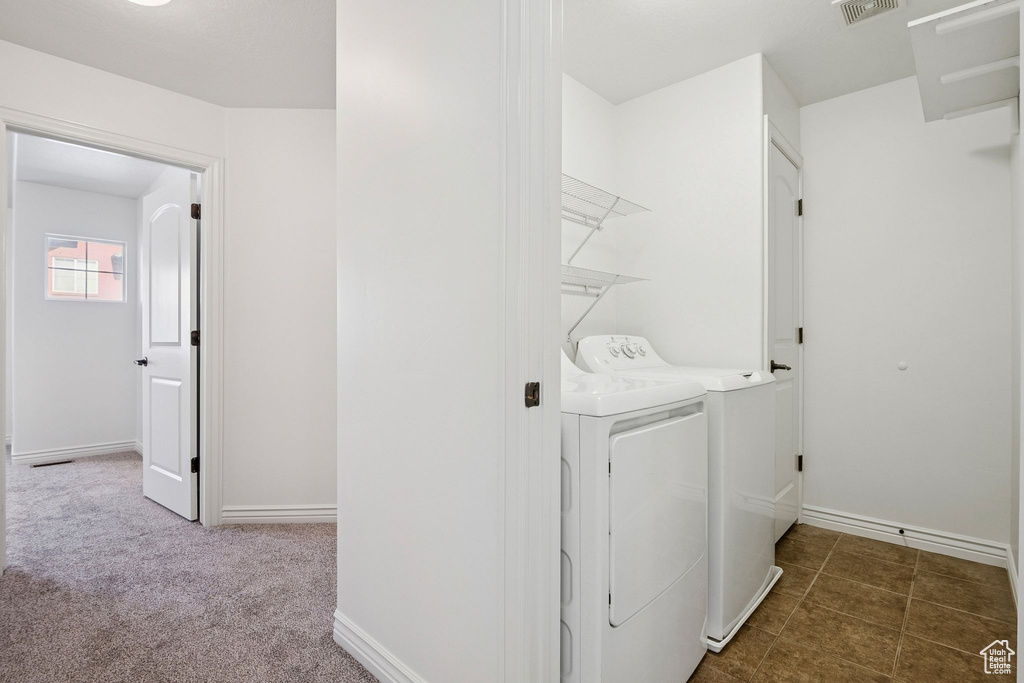 Washroom with separate washer and dryer and baseboards
