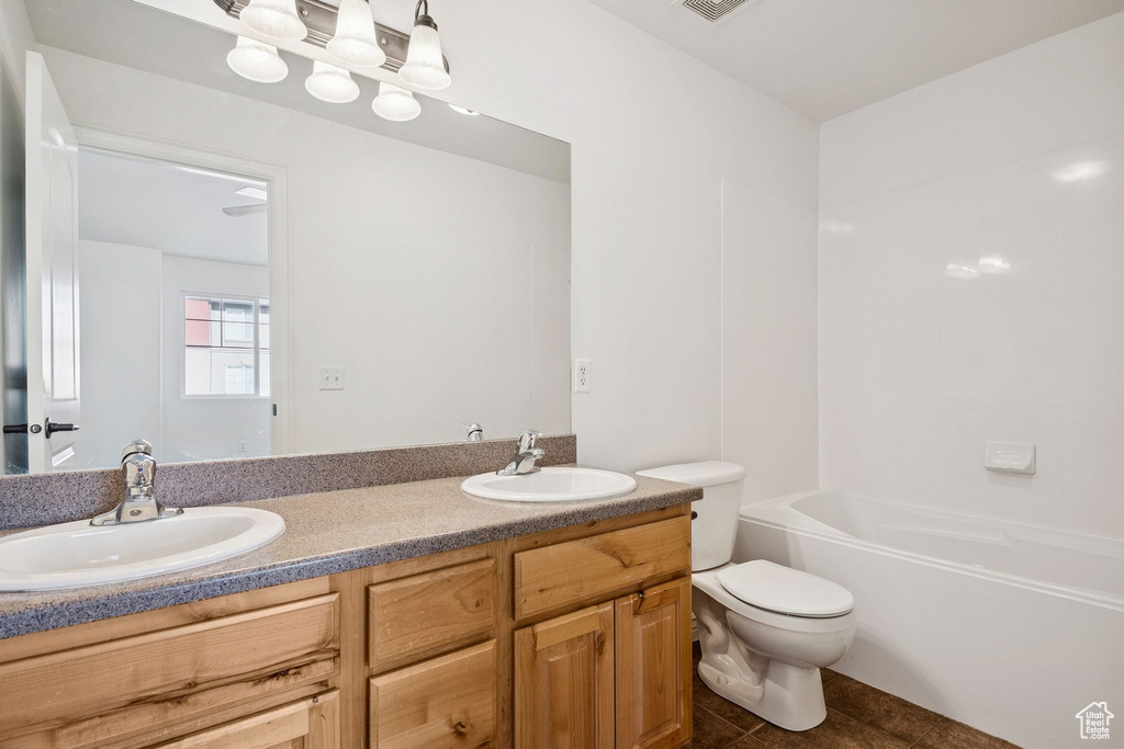 Bathroom featuring double vanity and tile patterned flooring