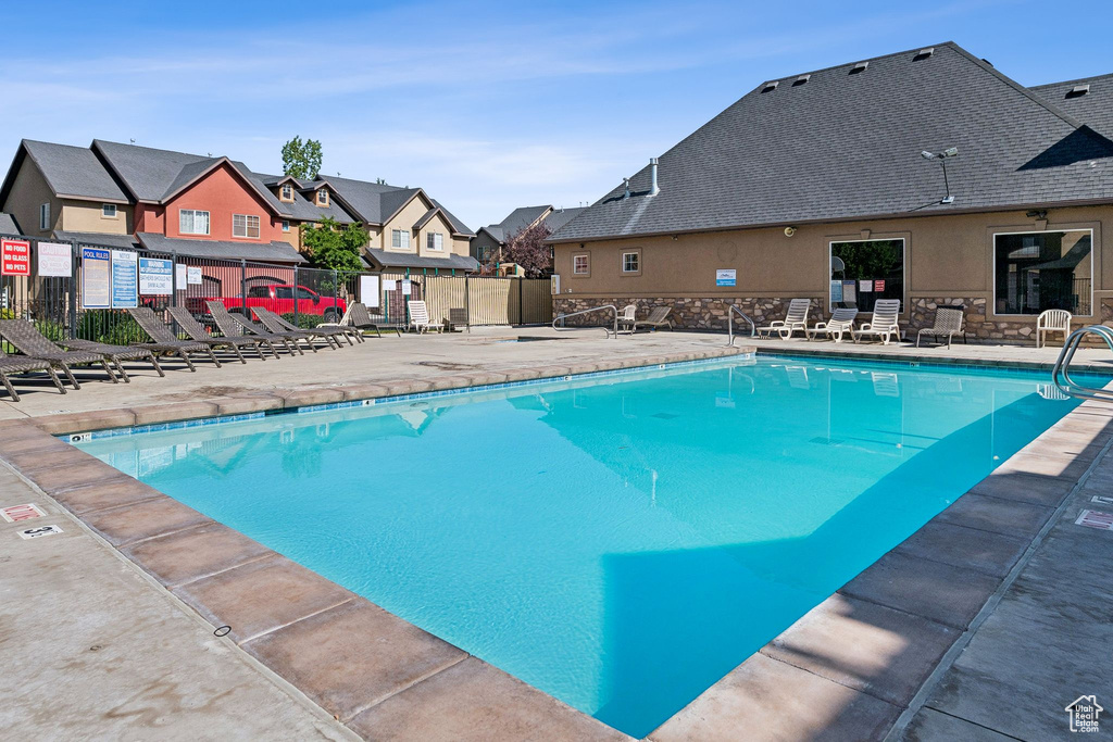 Community pool featuring a residential view and a patio area